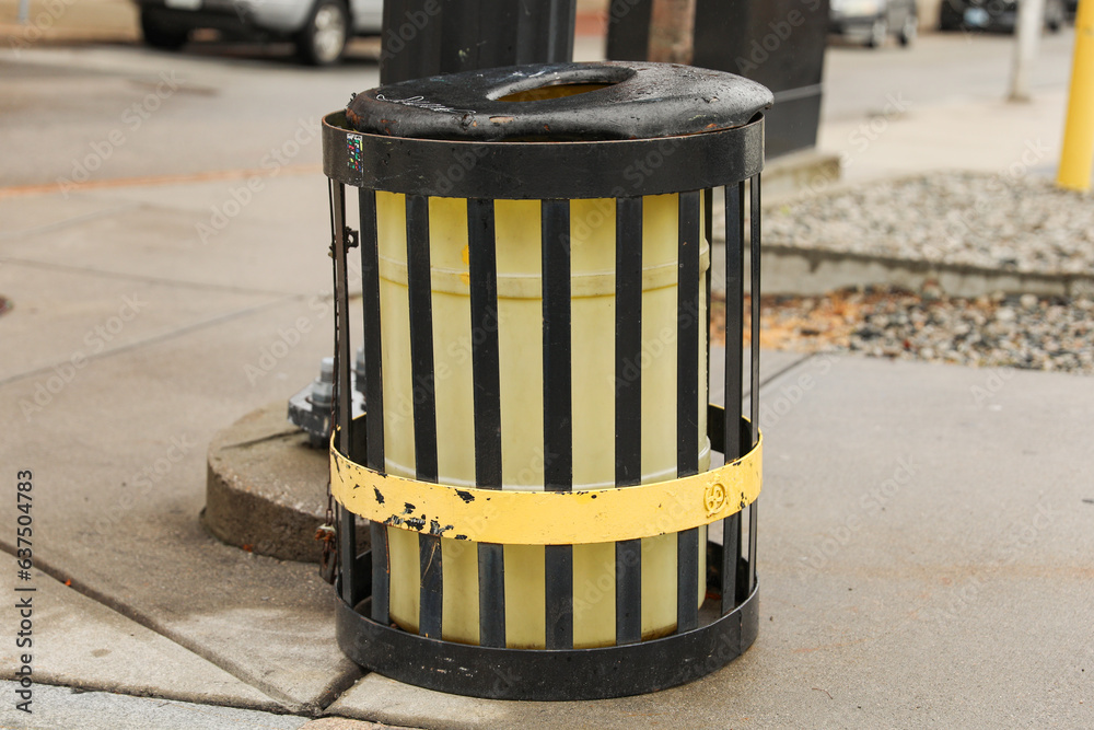 Foto de Lonely trashcan on urban street Symbolizes waste, consumption
