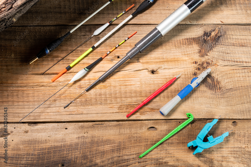 Tools and items for the fisherman. Tools on a wooden table. Warm light. View from above. Tools and items for the fisherman. Tools on a wooden table. Warm light. View from above.