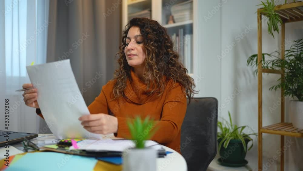 Young beautiful woman working on a laptop in her home office Young beautiful woman working on a laptop in her home office
