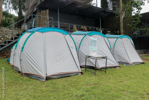 Camping and tent in the riverside. Natural area with trees and green grass