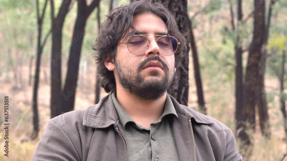 young man in a grove meditates deeply young man in a grove meditates deeply