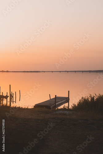 Boardwalk ocean swimming bridge in cozy warm sunset lighting.