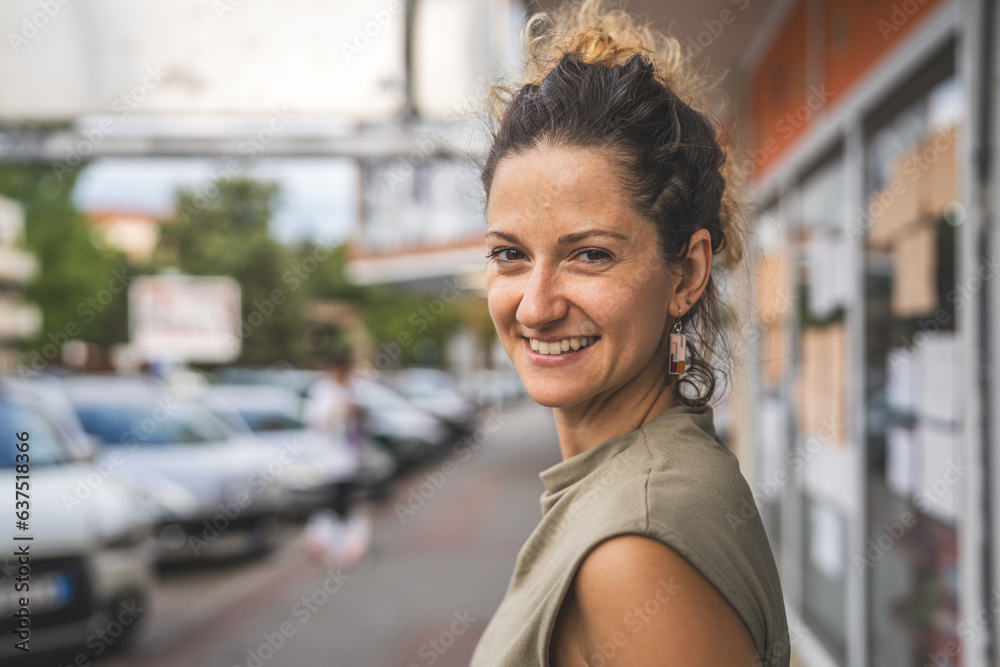 Portrait of adult caucasian woman stand in town or city outdoor in day