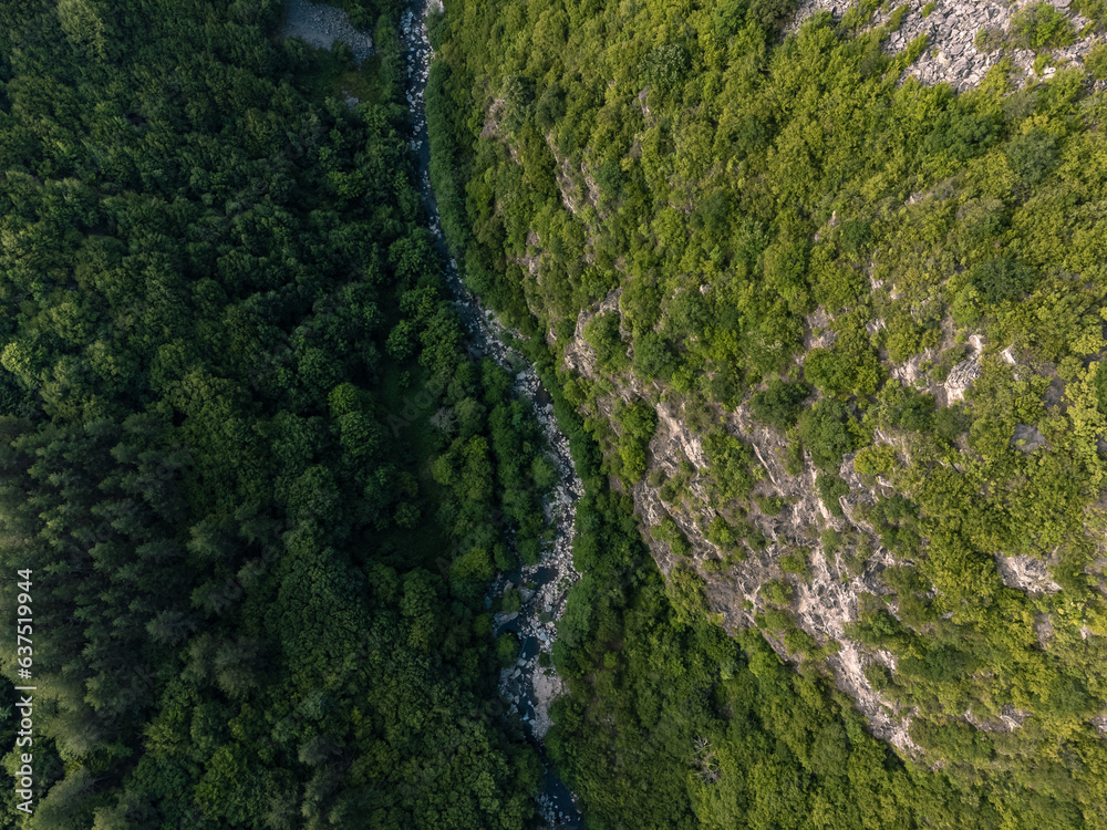 Above a river in between the valley. Shot with a drone. Above a river in between the valley. Shot with a drone.