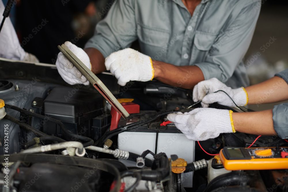 Car mechanics using digital endoscope and tablet computer when examining car engine Car mechanics using digital endoscope and tablet computer when examining car engine