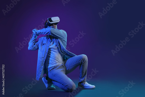 Young man using VR glasses ...