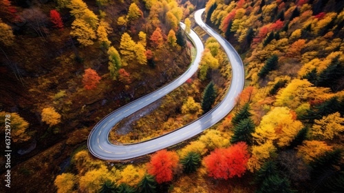 Aerial view of car traveling on winding mountain road in a forest. Generative AI