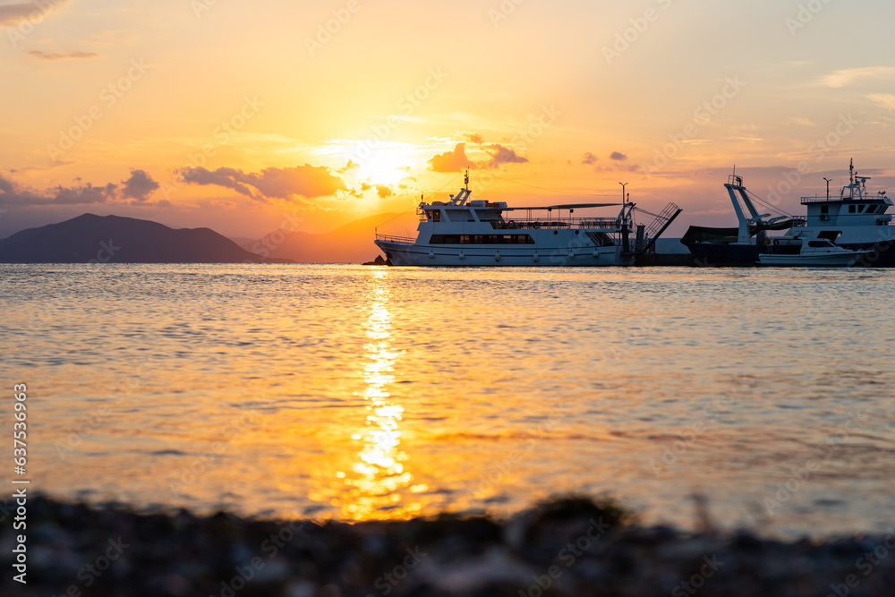 Ships and boats in harbour at sunset at the Greek island of Evia