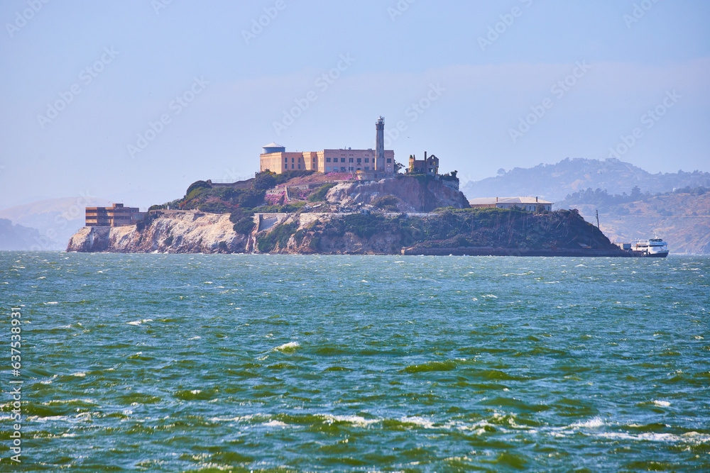 Choppy San Francisco Bay waters with full view of Alcatraz Island and docked boat