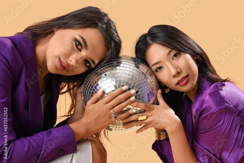 Two diverse women in purple...
