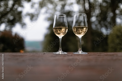 Pair of wine glasses on a table outdoors 