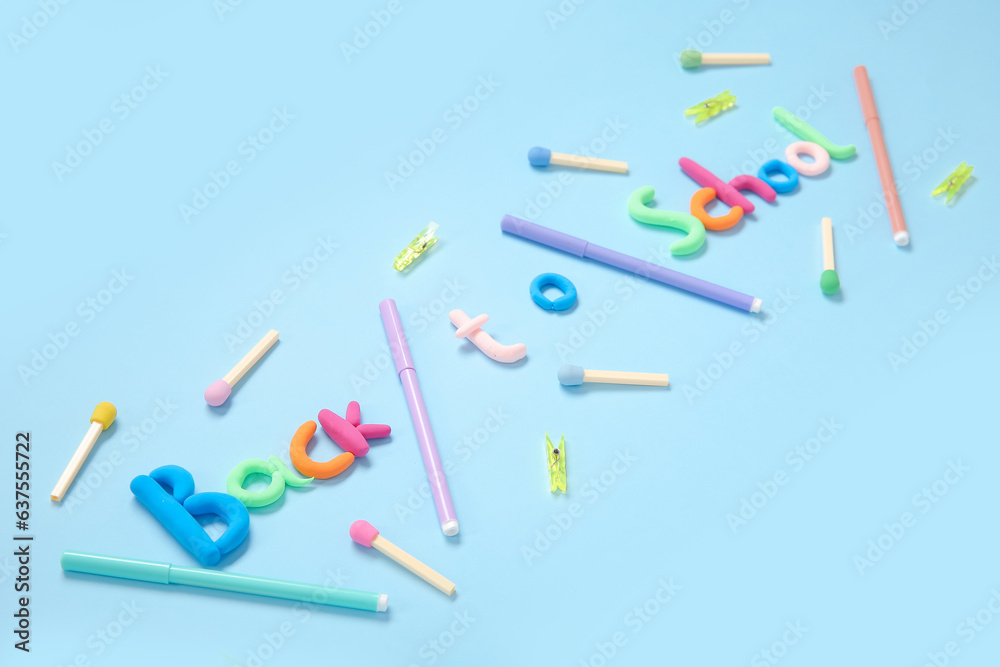 Text BACK TO SCHOOL and stationery on light blue background Text BACK TO SCHOOL and stationery on light blue background