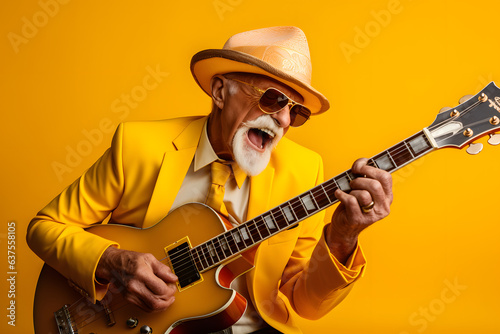 Extravagant cool funky old singer playing the guitar, photo studio, yellow background 