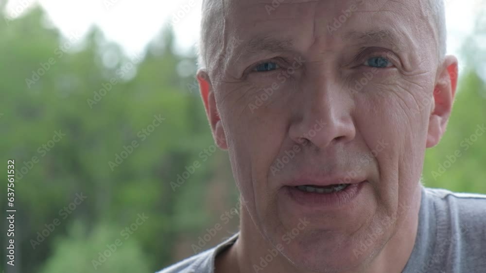 portrait of a man in years, an adult man against the background of trees portrait of a man in years, an adult man against the background of trees