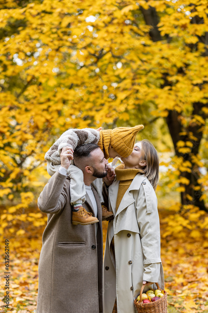Happy family on a beautiful fall picnic in the park. Cozy autumn vibes. Young father, mother and their cute sn spending quality time together, having fun. Happy family on a beautiful fall picnic in the park. Cozy autumn vibes. Young father, mother and their cute sn spending quality time together, having fun.