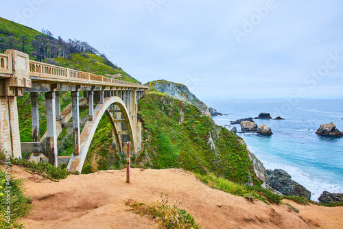 Rocky Creek Bridge with green hillside background and gorgeous Pacific Ocean coastline