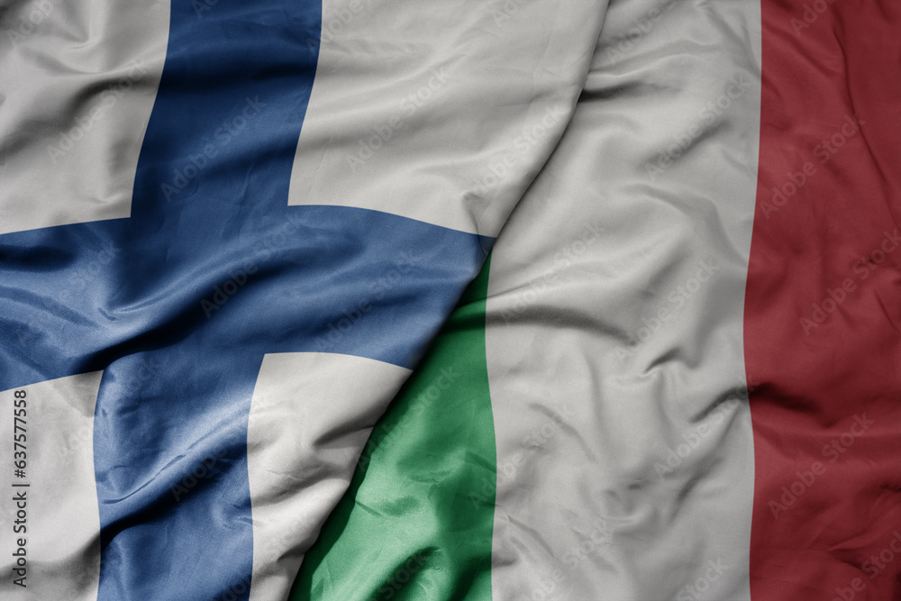 Fototapeta premium big waving national colorful flag of finland and national flag of italy .