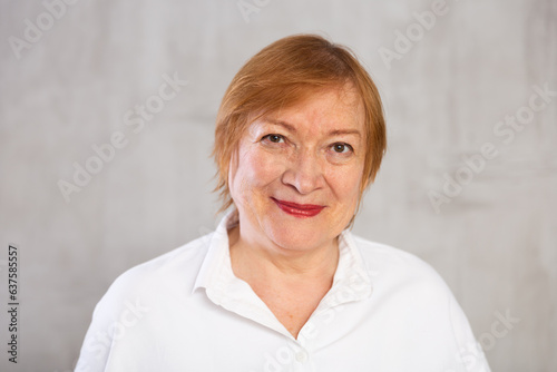 Older woman standing proudly with happy confident grin