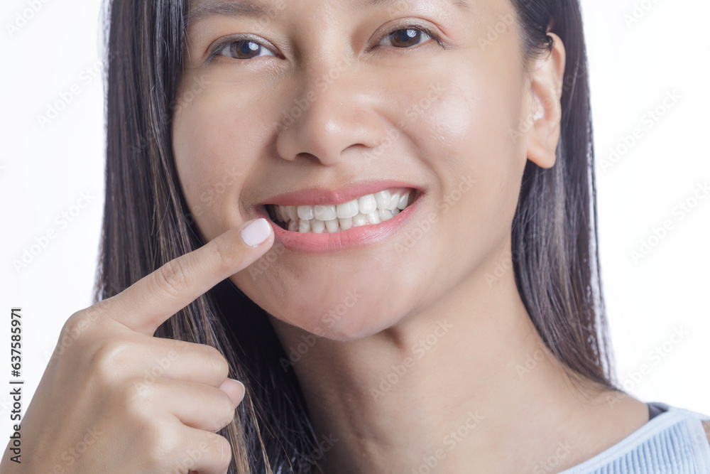 Asian American Woman pointing her perfect white Teeth Asian American Woman pointing her perfect white Teeth