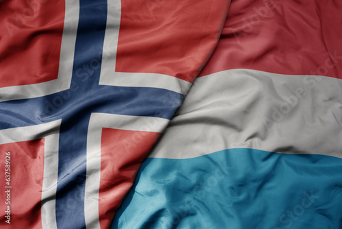 big waving national colorful flag of norway and national flag of .