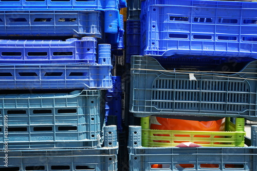 Gestapelte Plastikbehälter und Kisten aus Kunststoff in Blau und anderen Farben im Sommer bei Sonnenschein in den Gassen der Altstadt von Ayvalik in der Provinz Balikesir in der Türkei photo