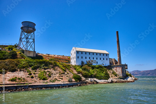Close up view of Alcatraz Island East side with water tower and white building with Indian Land