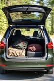 The trunk of a car full of suitcases and things. Travel by car.