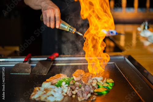 Chef cooking in Japanese teppanyaki restaurant