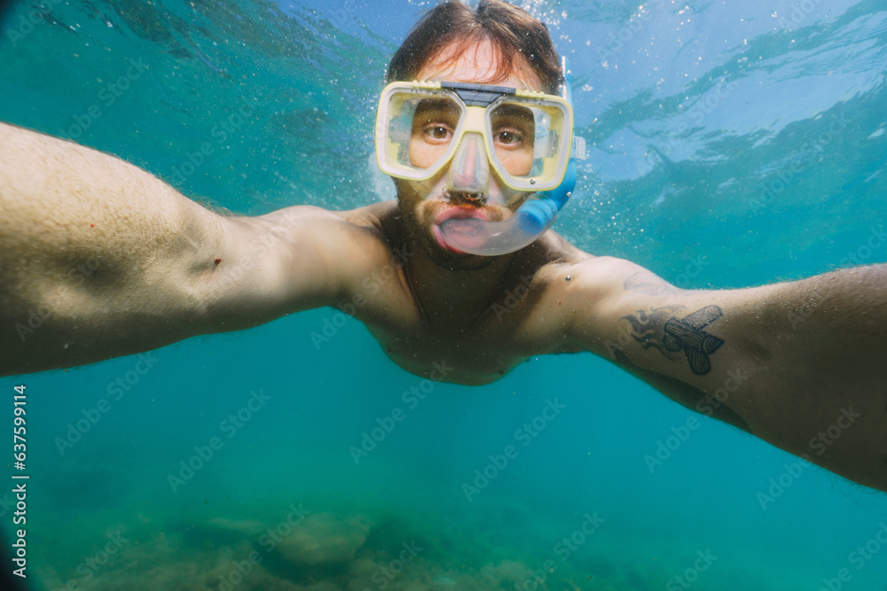 man taking a picture underwater