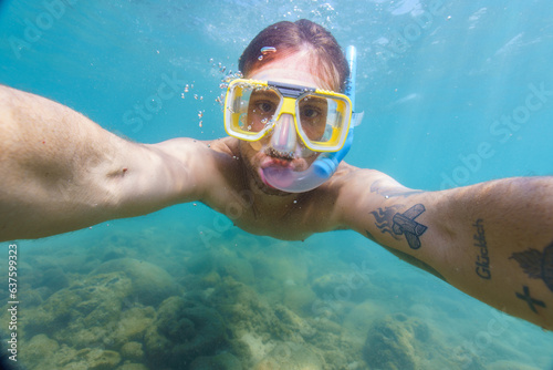 man taking a picture underwater