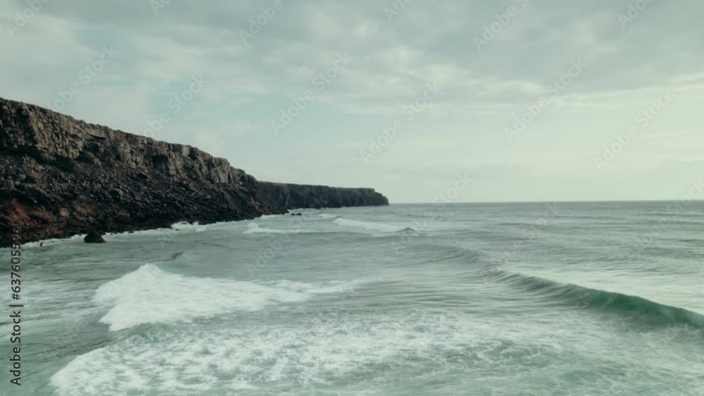 Sea waves wash the rocky mountains on the coast, a bird's-eye view from the sea Sea waves wash the rocky mountains on the coast, a bird's-eye view from the sea