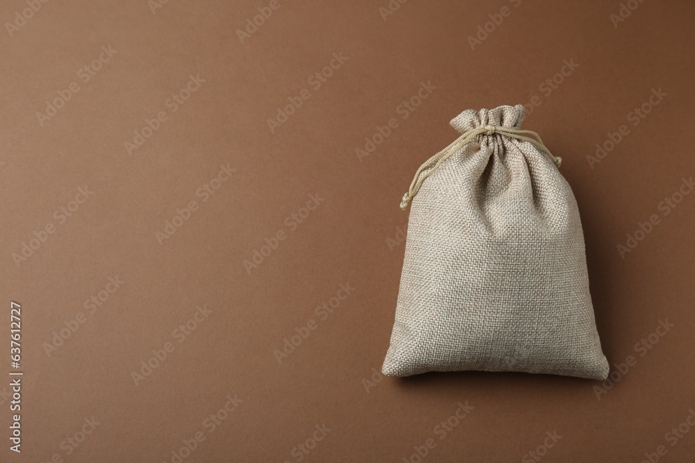 Burlap bag on brown background, top view. Space for text Burlap bag on brown background, top view. Space for text