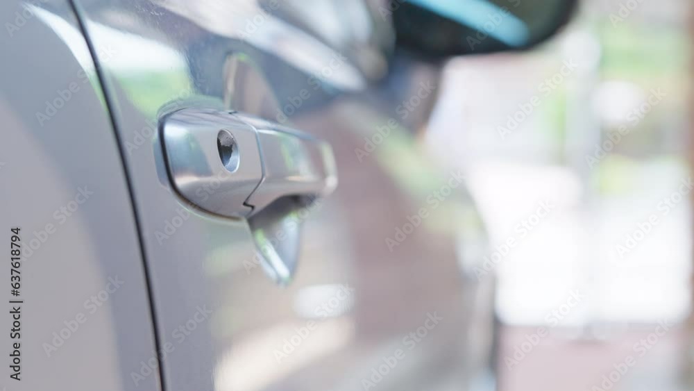 Hand with car key for open door. Concept of car insurance and owner Hand with car key for open door. Concept of car insurance and owner