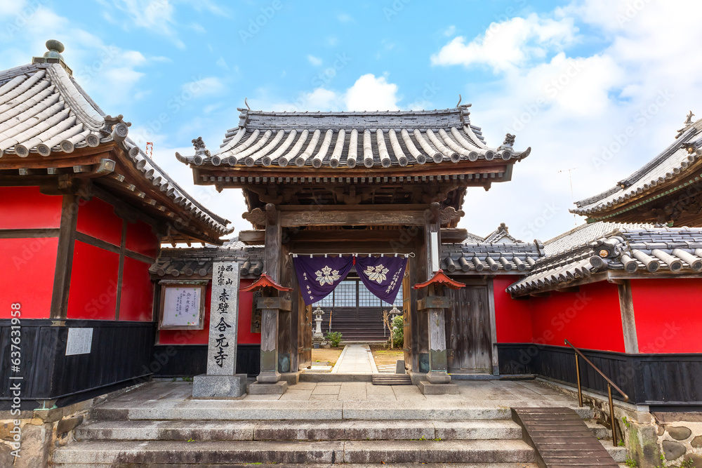 Nakatsu, Japan - Nov 26 2022: Goganji Temple (Red Wall Temple) established by daimyo Kuroda Yoshitaka and founded by the priest Kuyo, situated a little south of the center of the Tera-machi district Nakatsu, Japan - Nov 26 2022: Goganji Temple (Red Wall Temple) established by daimyo Kuroda Yoshitaka and founded by the priest Kuyo, situated a little south of the center of the Tera-machi district