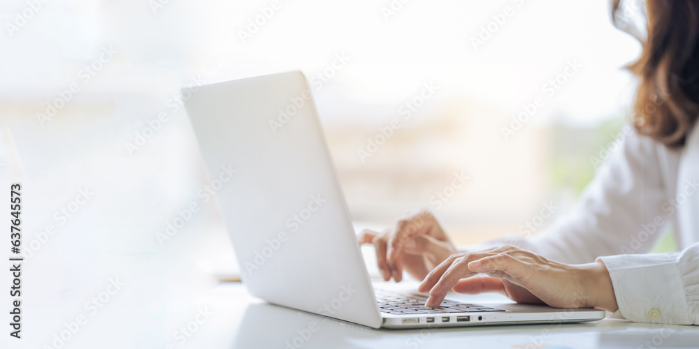 Closeup shot of hands using laptop and typing on keyboard, searching information Closeup shot of hands using laptop and typing on keyboard, searching information