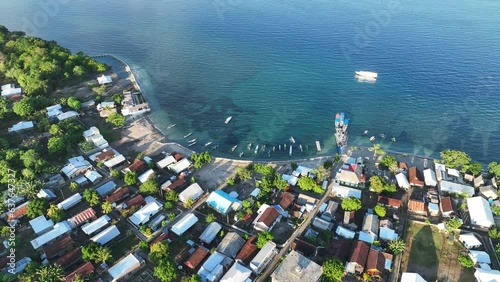 Morning light illuminates a fishing village on an island found just off the north coast of Sumbawa in Indonesia. This volcanic region, in the ring of fire, harbors high marine biodiversity. photo