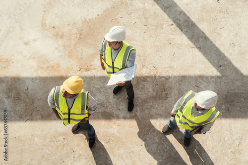 Top view, Building Project with Civil Engineer, Contractor and Architect check blueprint and discussing plan details.