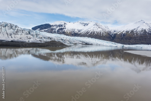 reflection on a lake in snow capped mountains