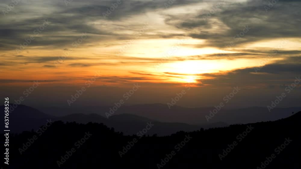 The breathtaking beauty of a 4K video timelapse capturing the mesmerizing sunset over the majestic mountain. Phu Soi Dao National Park, Thailand The breathtaking beauty of a 4K video timelapse capturing the mesmerizing sunset over the majestic mountain. Phu Soi Dao National Park, Thailand