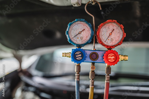 Close-up of car air conditioning manifold gauges.