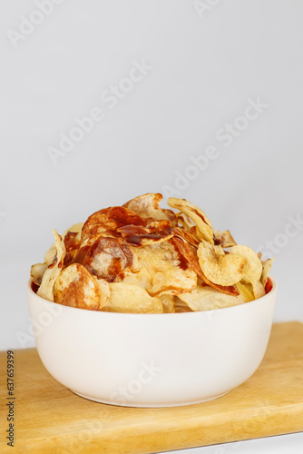 chips served in a bowl with hot sauce