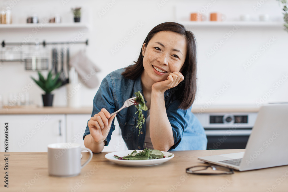Brunette eating salad during break from work at home Brunette eating salad during break from work at home