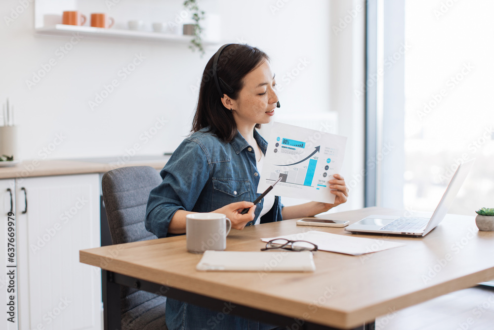 Woman analyzing graph on video conference via laptop at home Woman analyzing graph on video conference via laptop at home