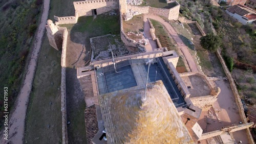 Panoramic aerial drone view of old medieval tower and castle wall of old Benabarre castle and view of surrounding area, perfect example of beautifully landscaped ancient architecture. Aragon, Spain.4K photo