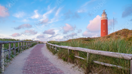 Fototapeta Naklejka Na Ścianę i Meble -  Texell lighthouse during sunset Netherlands Dutch Island Texel in summer with sand dunes at the Wadden Island