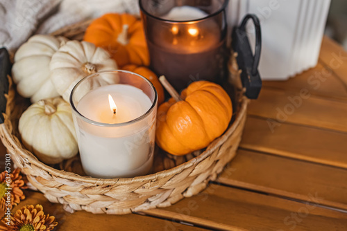 Fototapeta Naklejka Na Ścianę i Meble -  Cozy fall still life composition with decorative pumpkins and burning candle.