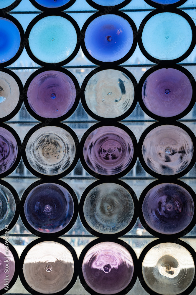 Close up photo of beautiful blue and purple circular glass window in Venice, Italy. Close up photo of beautiful blue and purple circular glass window in Venice, Italy.