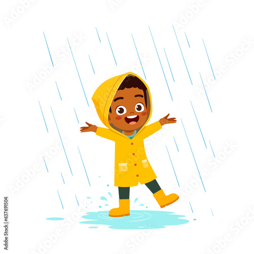 little kid wearing yellow rain coat in the rain and feel happy