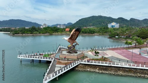 Aerial Panning Shot Of Tourists By Eagle Statue At Dataran Lang On Sea Near Mountains - Langkawi, Malaysia