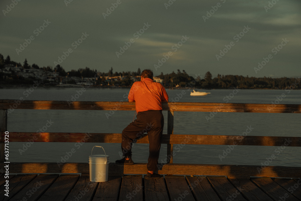 person on the pier looking for fish 
